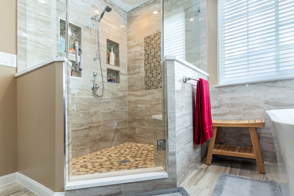 Large modern master bathroom in DC Metro with shaker cabinets, dark wood cabinets, a freestanding tub, a corner shower, a two-piece toilet, beige tile, porcelain tile, beige walls, porcelain floors, an undermount sink, engineered quartz benchtops, beige floor, a hinged shower door and white benchtops.