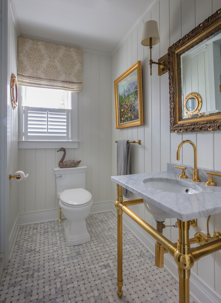 Design ideas for a mid-sized traditional powder room in Baltimore with beige walls, ceramic floors, marble benchtops, grey floor, grey benchtops, a console sink and planked wall panelling.