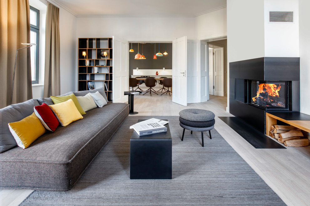 Inspiration for an expansive contemporary formal enclosed living room in Berlin with white walls, light hardwood floors, a corner fireplace, no tv and beige floor.