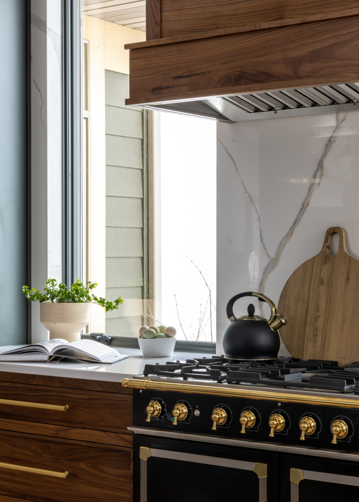 Eat-in kitchen - mid-sized transitional l-shaped light wood floor and brown floor eat-in kitchen idea with a farmhouse sink, shaker cabinets, blue cabinets, quartz countertops, white backsplash, quartz backsplash, black appliances, an island and white countertops