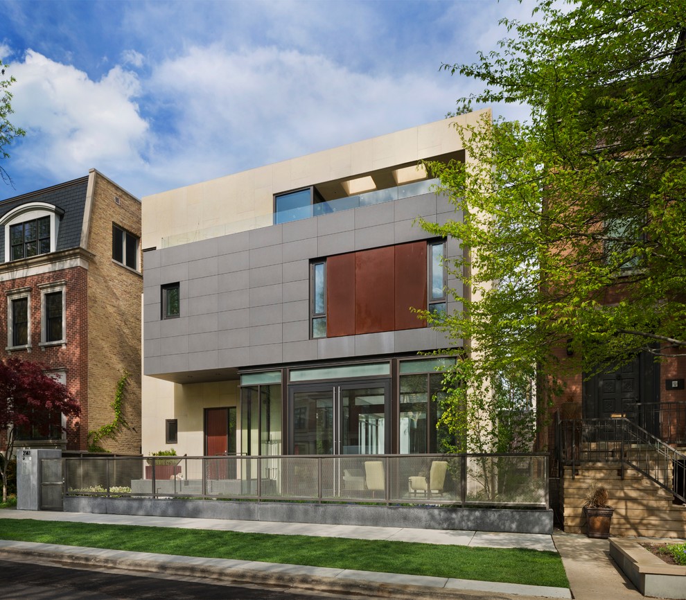 Design ideas for a large modern three-storey grey exterior in Chicago with concrete fiberboard siding and a flat roof.