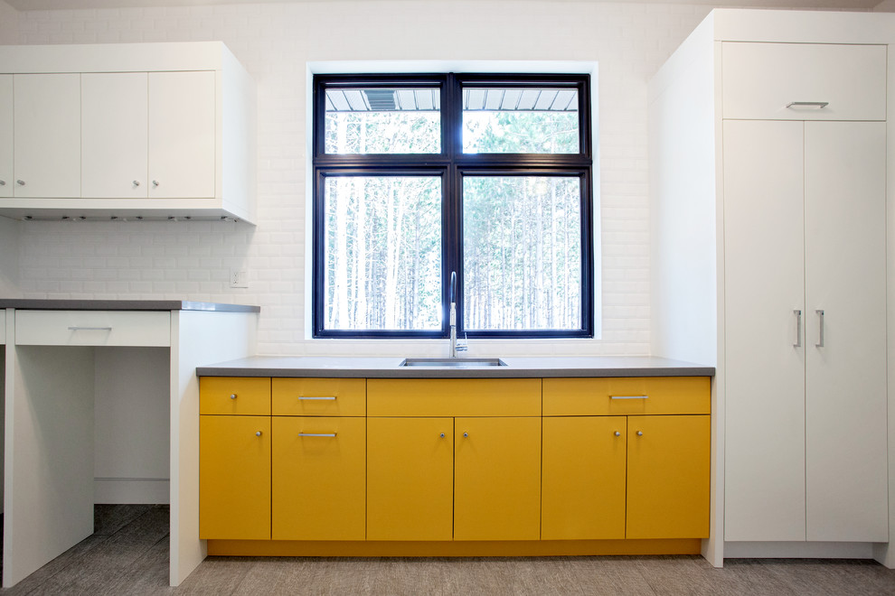 Design ideas for a large modern l-shaped dedicated laundry room in Toronto with an undermount sink, flat-panel cabinets, yellow cabinets, quartz benchtops, white walls, porcelain floors and a side-by-side washer and dryer.