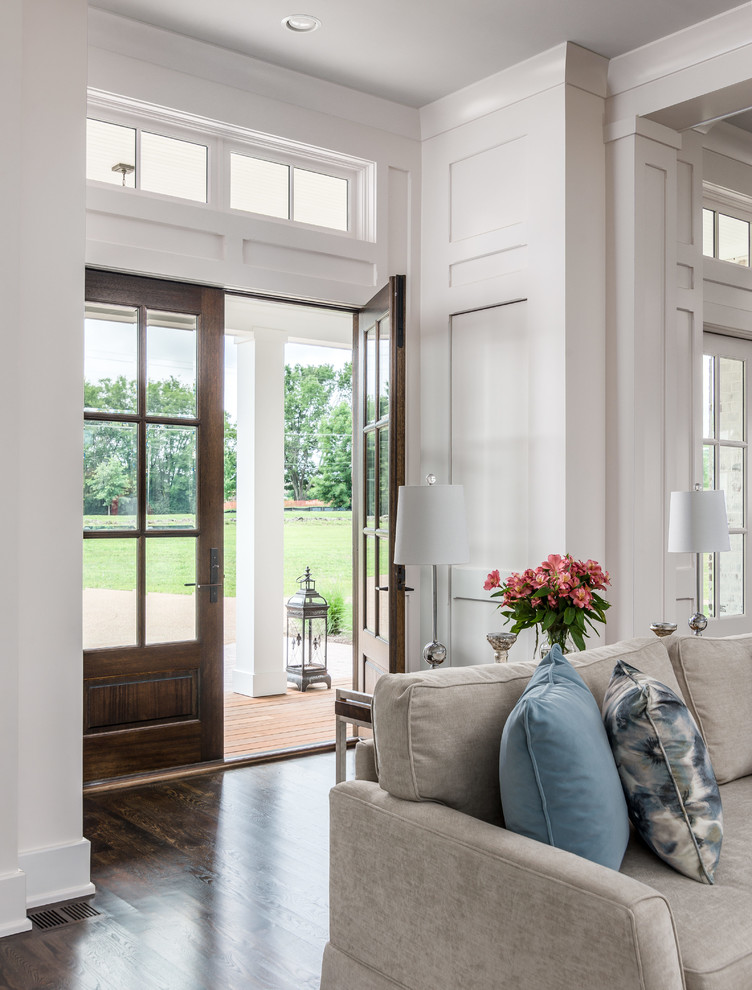 Example of a transitional dark wood floor and brown floor foyer design in Nashville with white walls and a dark wood front door