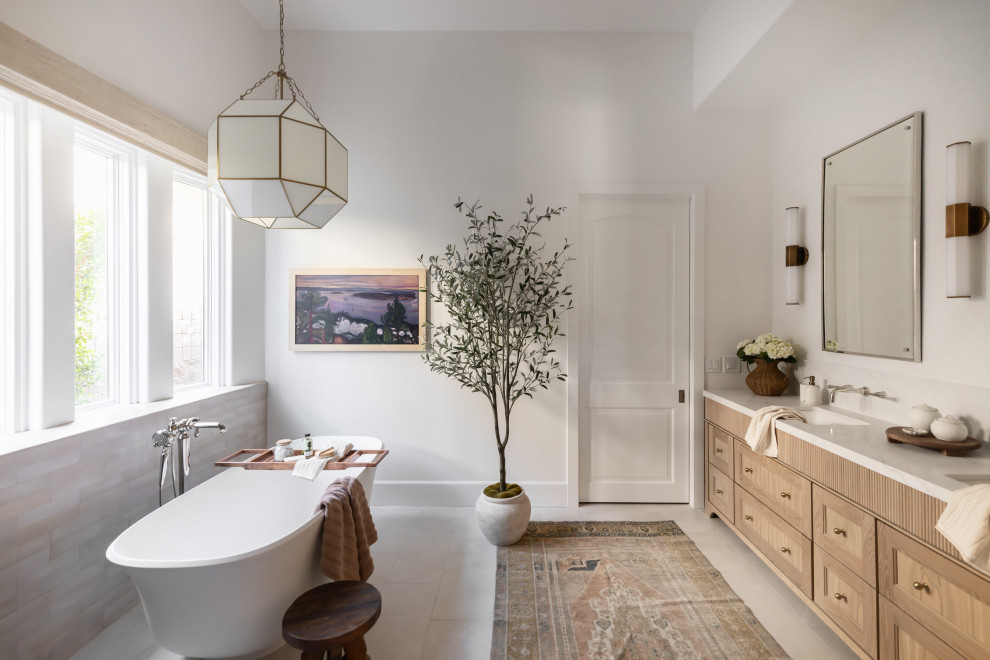 Bathroom - large transitional master beige tile and porcelain tile porcelain tile, beige floor, double-sink and wallpaper bathroom idea in Phoenix with brown cabinets, white walls, an undermount sink, quartz countertops, a hinged shower door, white countertops, a freestanding vanity and recessed-panel cabinets