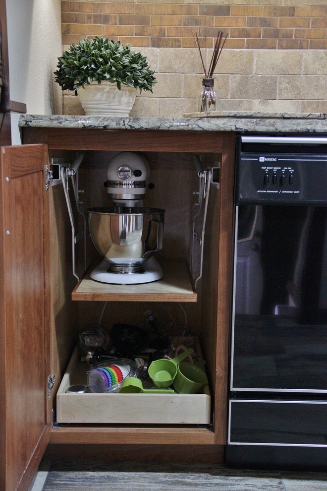 Enclosed kitchen - mid-sized transitional galley ceramic tile enclosed kitchen idea with an undermount sink, shaker cabinets, medium tone wood cabinets, quartz countertops, beige backsplash, stone tile backsplash, stainless steel appliances and a peninsula