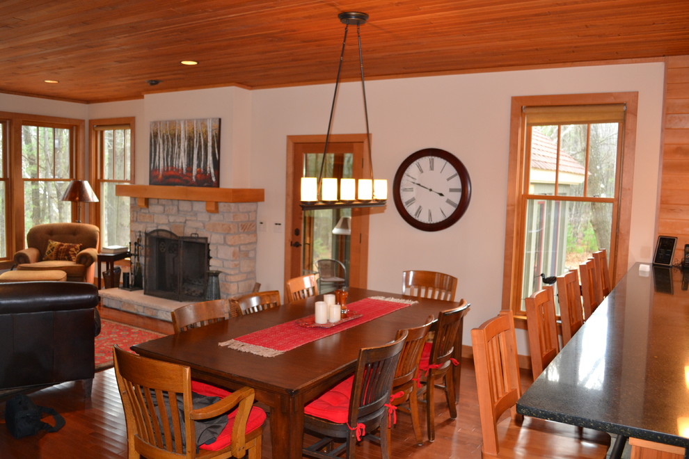 Example of a mid-sized mountain style dark wood floor kitchen/dining room combo design with white walls