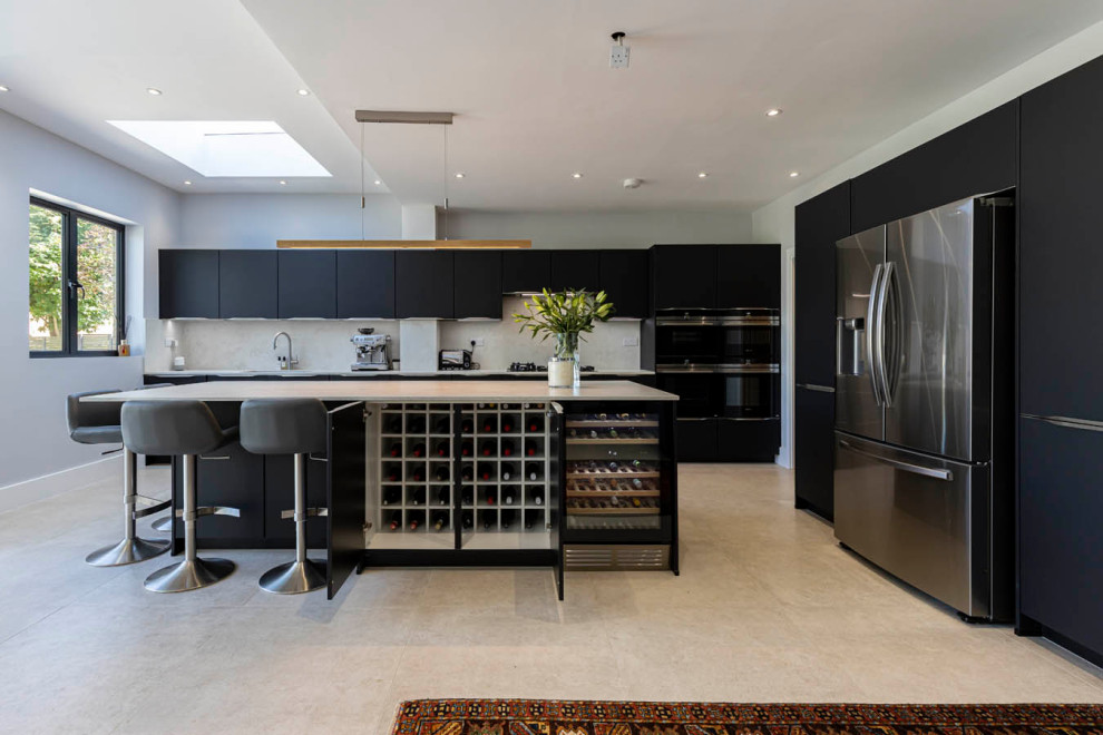 Design ideas for a large modern galley open plan kitchen in Hertfordshire with a single-bowl sink, flat-panel cabinets, black cabinets, concrete worktops, white splashback, black appliances, ceramic flooring, an island, grey floors and white worktops.