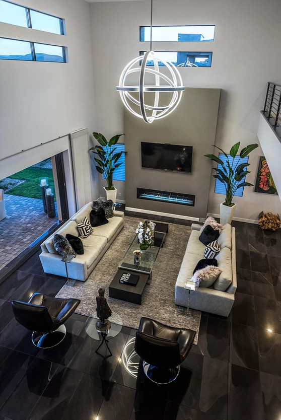 Inspiration for a large contemporary open concept living room in Las Vegas with grey walls, a ribbon fireplace, a wall-mounted tv and black floor.