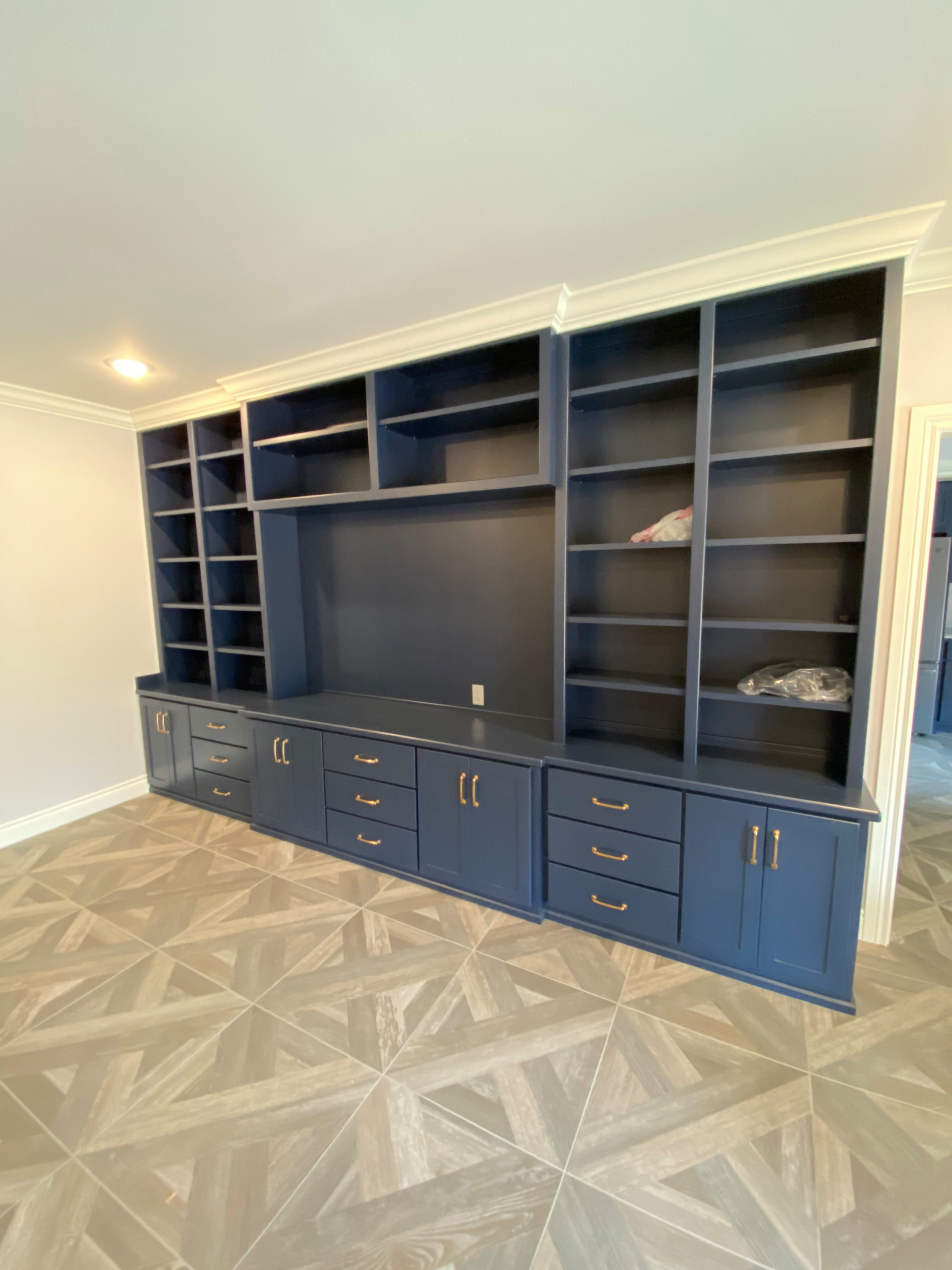 Custom painted built-in cabinet in basement living room