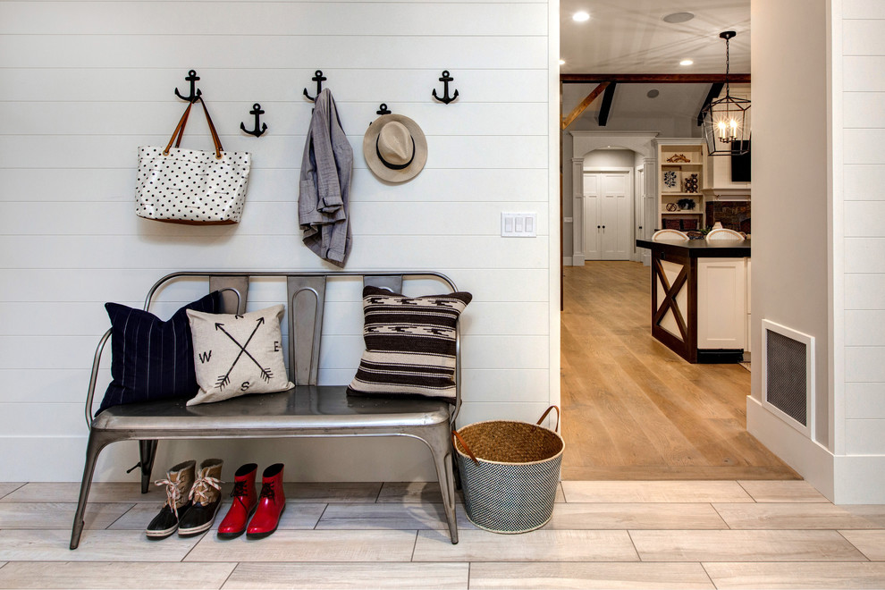 Design ideas for a beach style entryway in Salt Lake City with white walls and light hardwood floors.