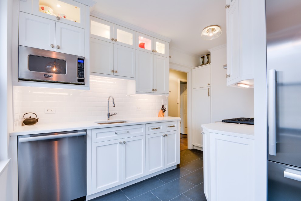 Inspiration for a mid-sized transitional u-shaped gray floor eat-in kitchen remodel with an undermount sink, shaker cabinets, white cabinets, stainless steel appliances and no island