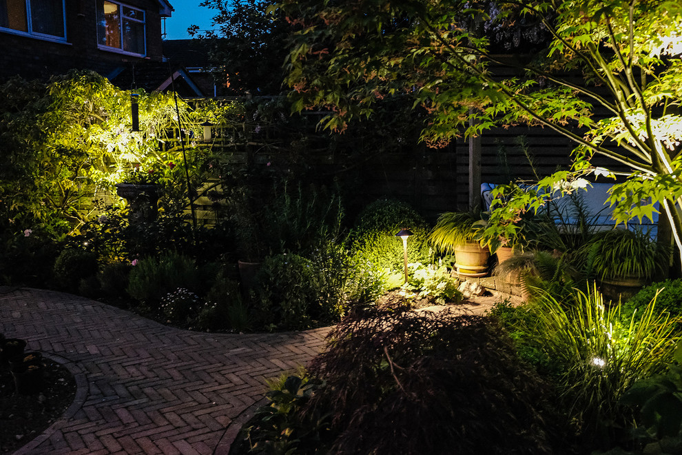 Photo of a small contemporary courtyard partial sun garden for summer in Hertfordshire with brick pavers.