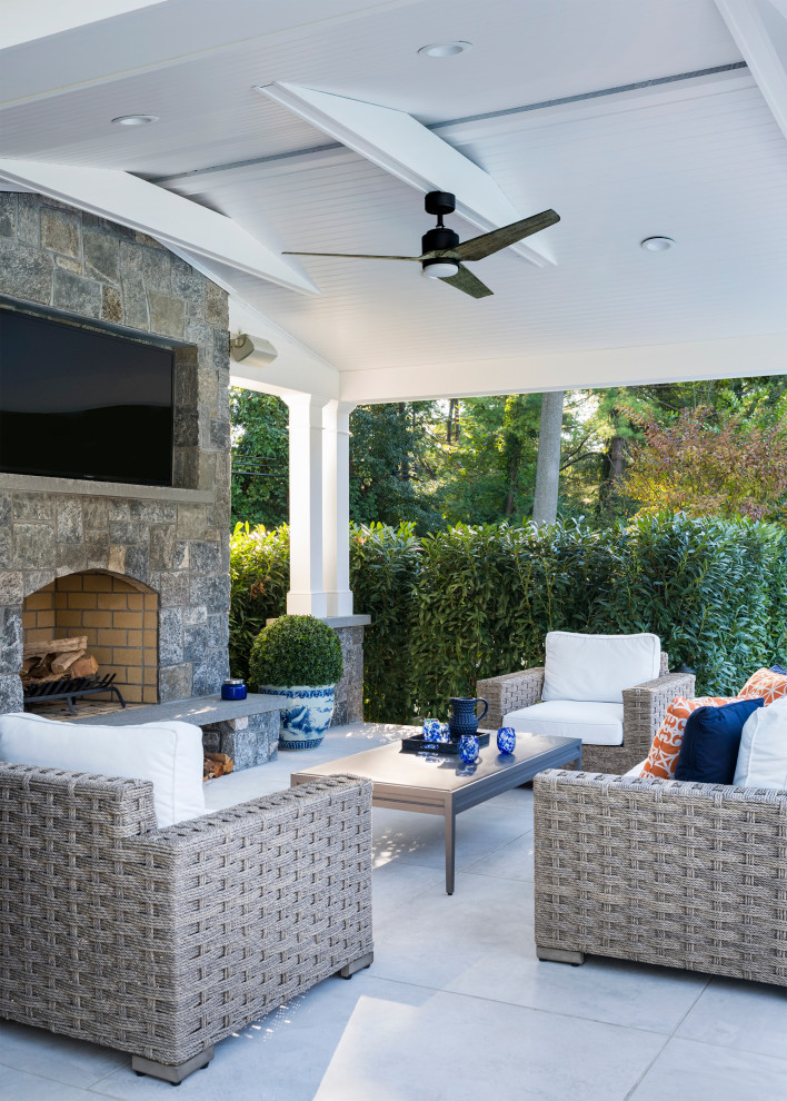 Patio - large transitional backyard concrete paver patio idea in New York with a gazebo and a fireplace