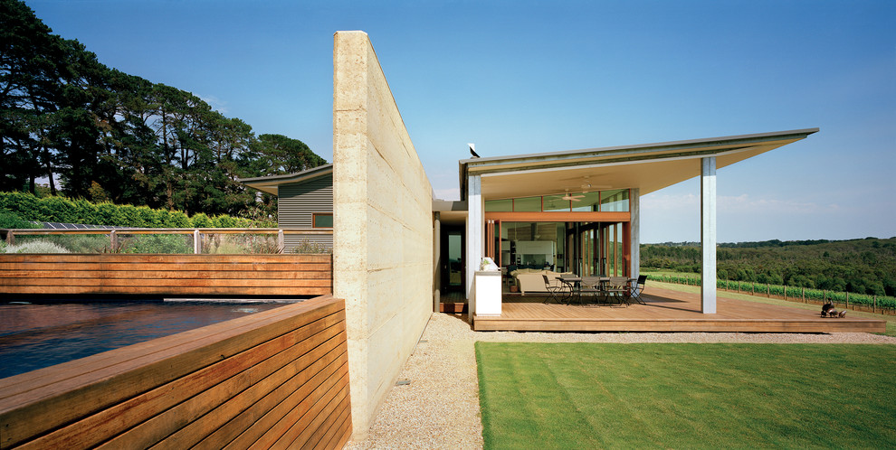 This is an example of a large modern split-level exterior in Melbourne with mixed siding and a shed roof.