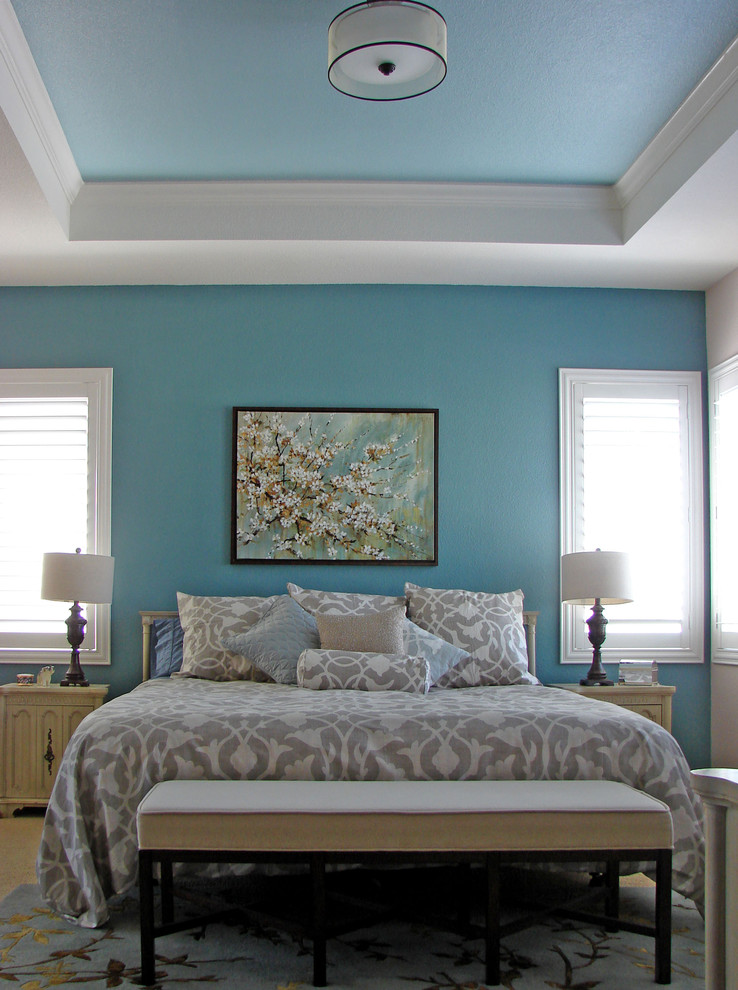 Mid-sized contemporary master bedroom in Los Angeles with blue walls, carpet, no fireplace and beige floor.