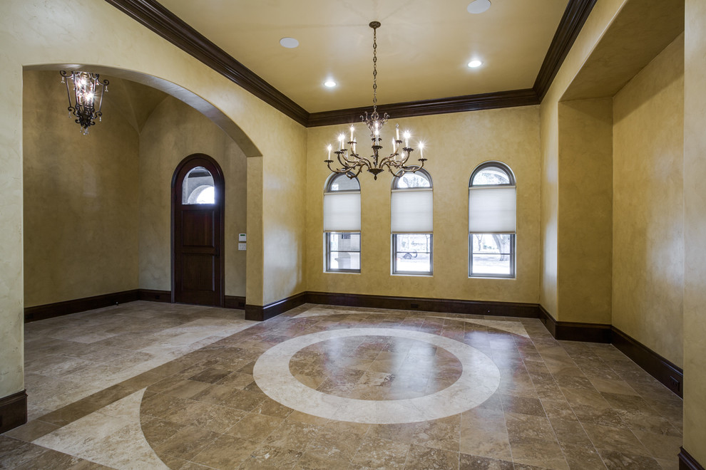Photo of a large mediterranean foyer in Dallas with beige walls, travertine floors, a single front door and a dark wood front door.