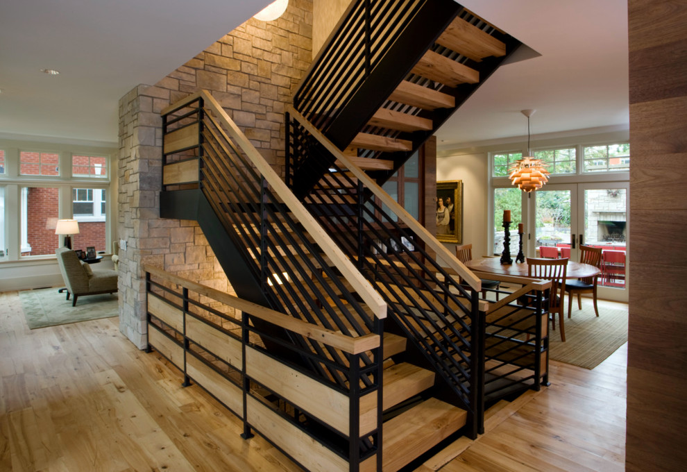 Photo of a large country wood l-shaped staircase in Chicago with open risers.