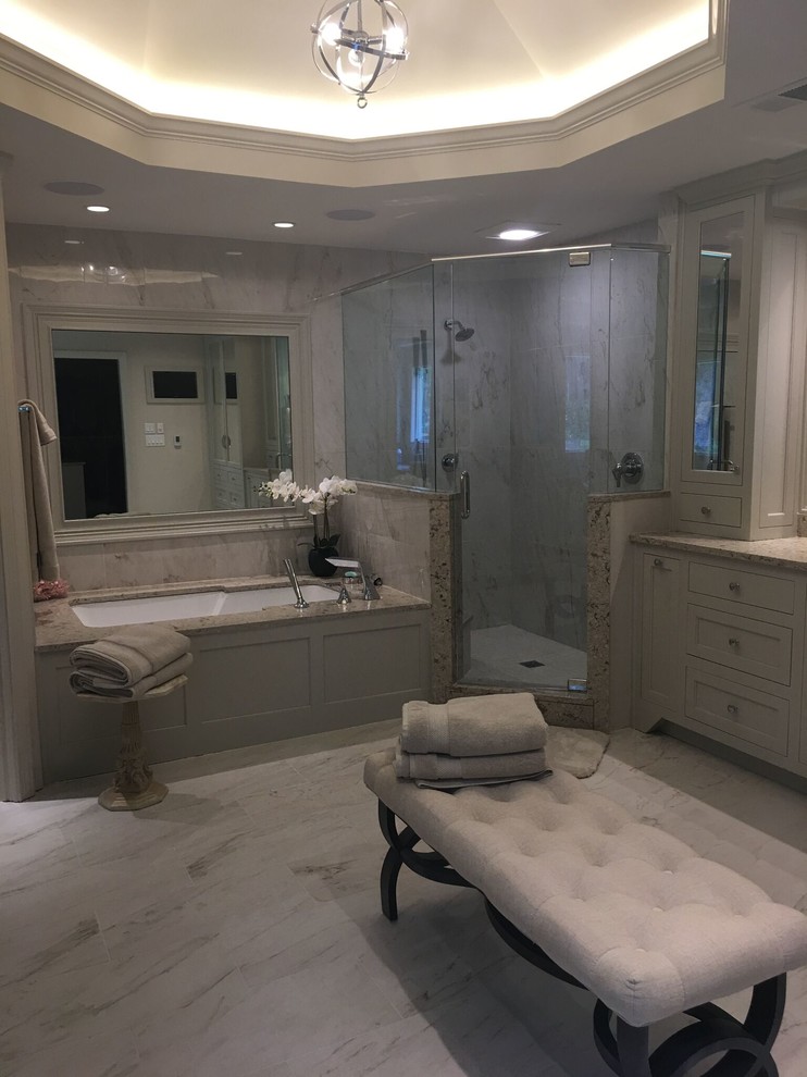 Photo of a large transitional master bathroom in Atlanta with shaker cabinets, white cabinets, an undermount tub, a corner shower, beige walls, an undermount sink, granite benchtops, beige floor and a hinged shower door.