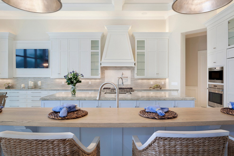 Inspiration for a large transitional u-shaped porcelain tile and beige floor open concept kitchen remodel in Miami with an undermount sink, recessed-panel cabinets, white cabinets, marble countertops, multicolored backsplash, subway tile backsplash, stainless steel appliances, an island and multicolored countertops
