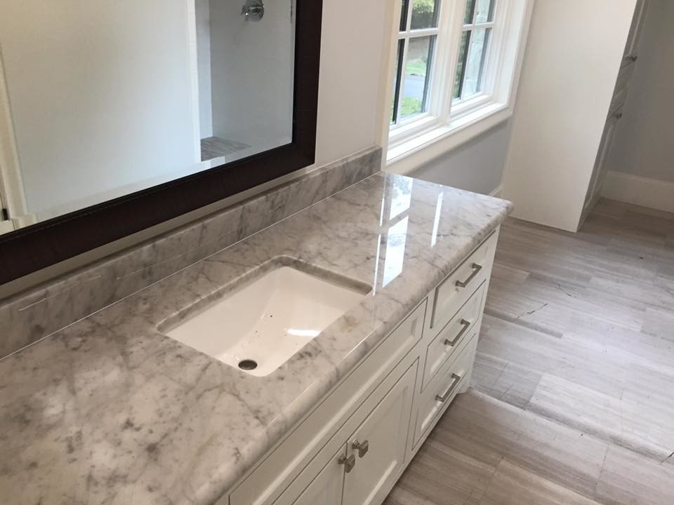Bathroom - mid-sized transitional master light wood floor bathroom idea in Dallas with flat-panel cabinets, white cabinets, white walls, an undermount sink and granite countertops
