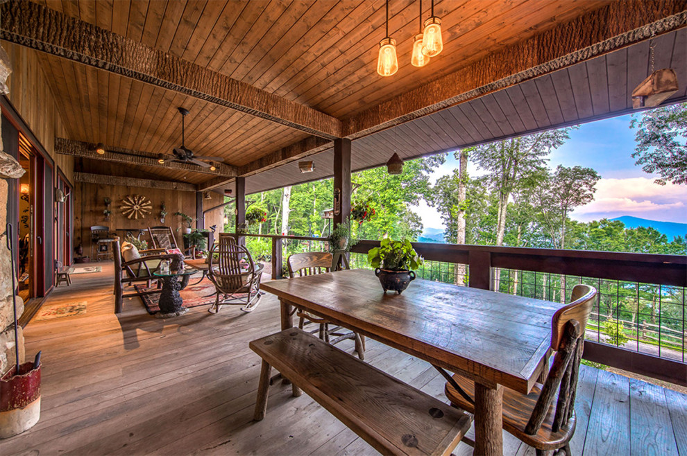 This is an example of a rustic porch design with decking and a roof extension.