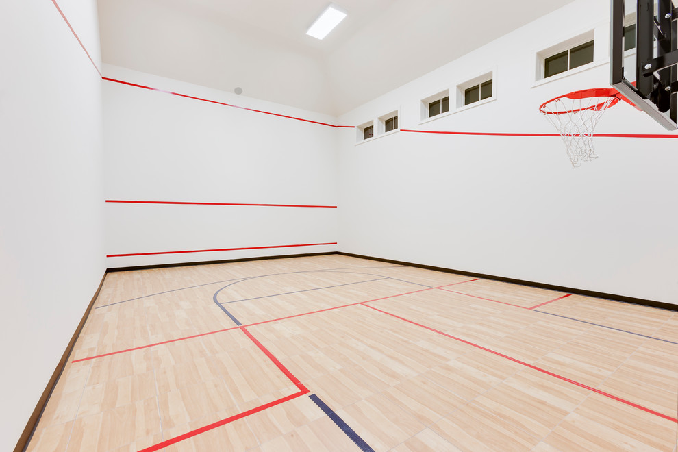 Inspiration for an expansive transitional indoor sport court in Minneapolis with white walls and vinyl floors.