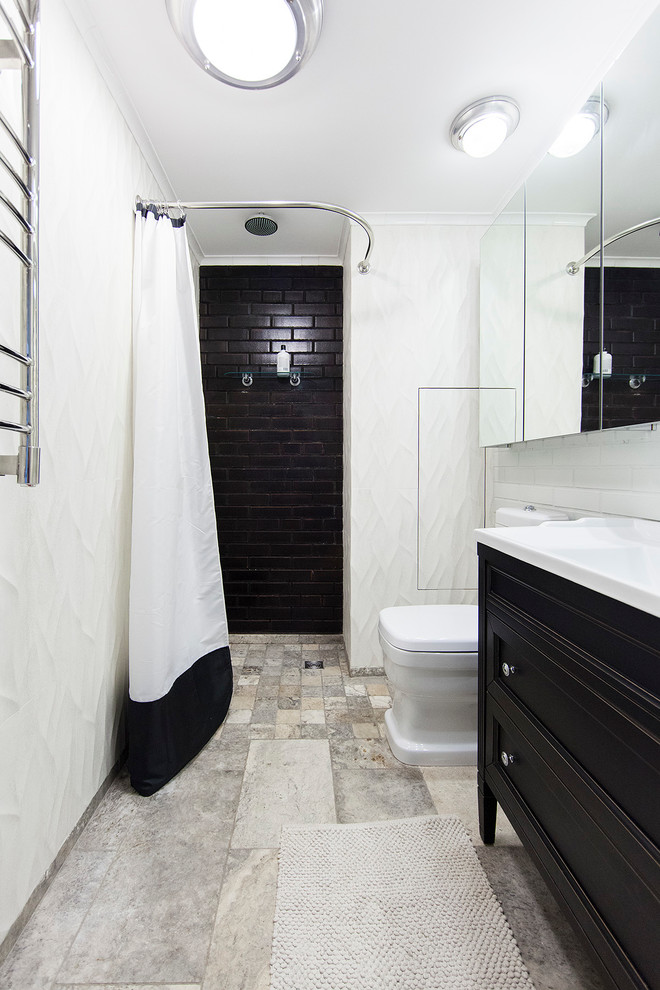 Inspiration for an industrial 3/4 bathroom in Moscow with recessed-panel cabinets, black cabinets, an alcove shower, a two-piece toilet, black tile, white walls and a shower curtain.