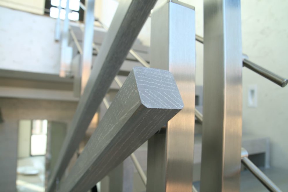 Modern metal stair covered by patina oak