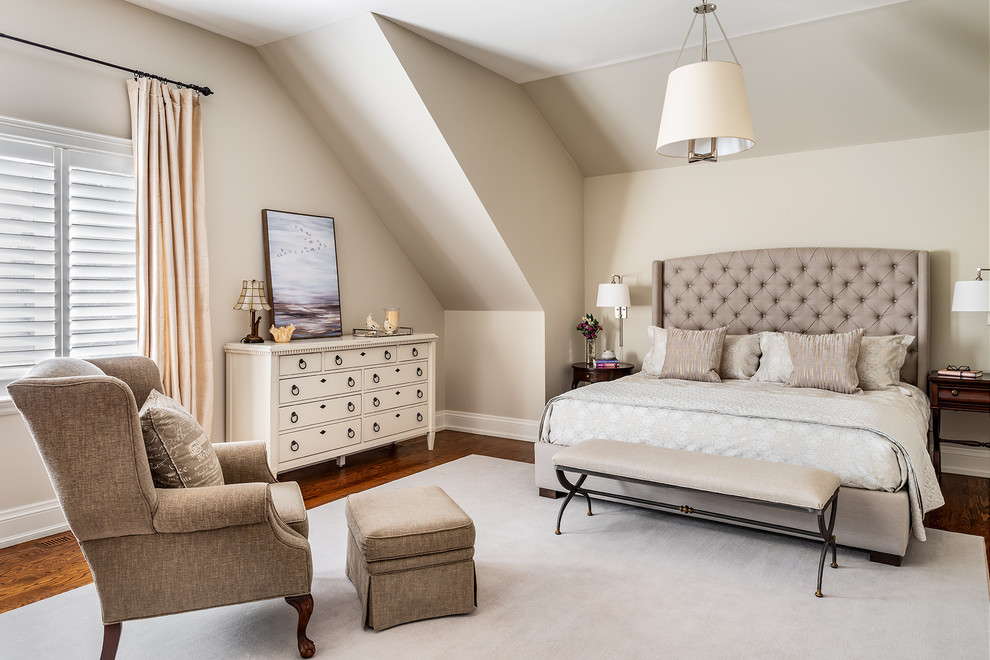 Large traditional master bedroom in Toronto with beige walls, medium hardwood floors and brown floor.