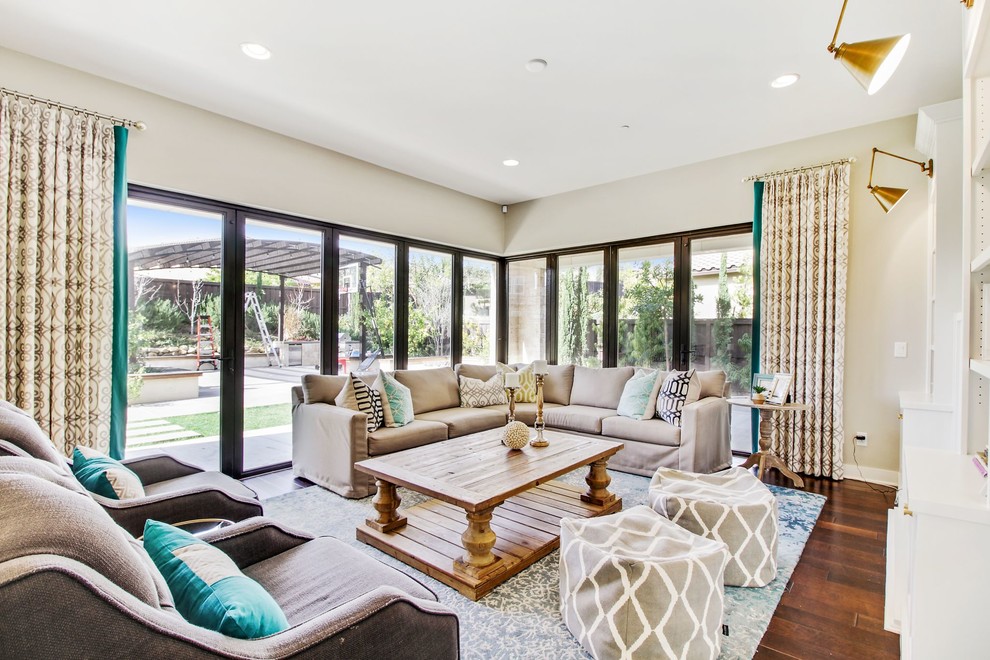 Transitional open concept family room in San Diego with beige walls and dark hardwood floors.