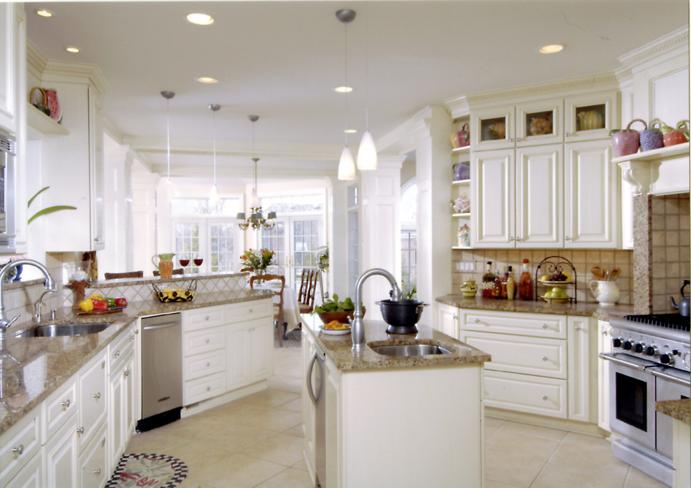 Photo of a traditional u-shaped open plan kitchen in DC Metro with a single-bowl sink, beaded inset cabinets, white cabinets, granite benchtops, beige splashback, ceramic splashback, stainless steel appliances, ceramic floors and with island.