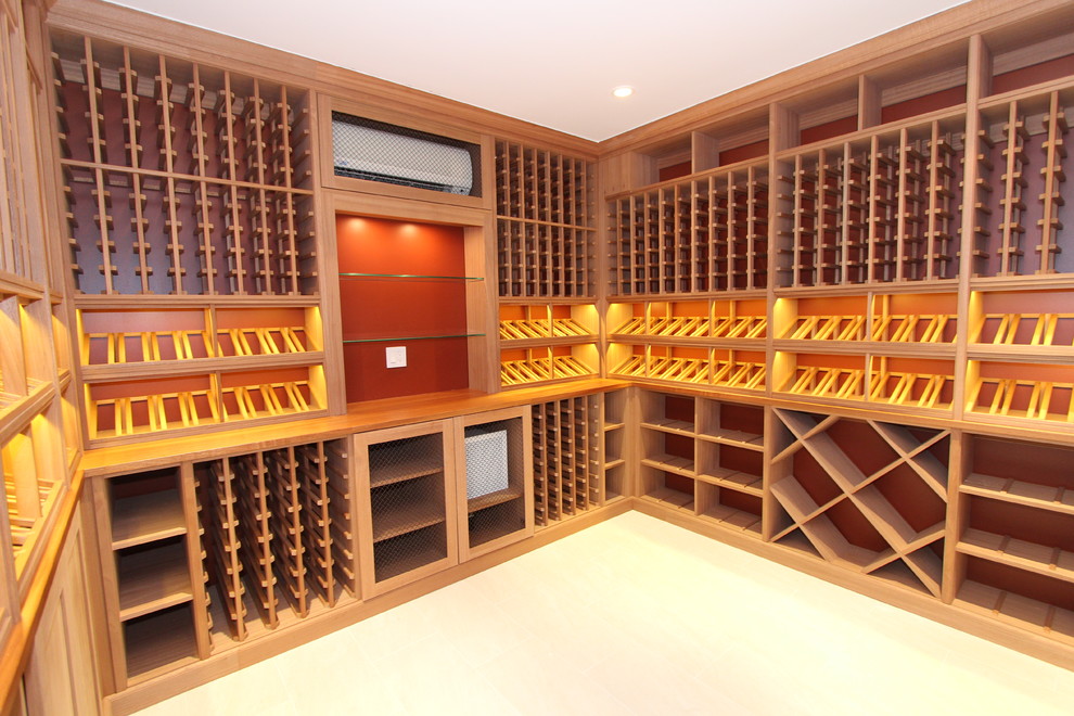 Photo of a mid-sized contemporary wine cellar in New York with light hardwood floors, display racks and beige floor.