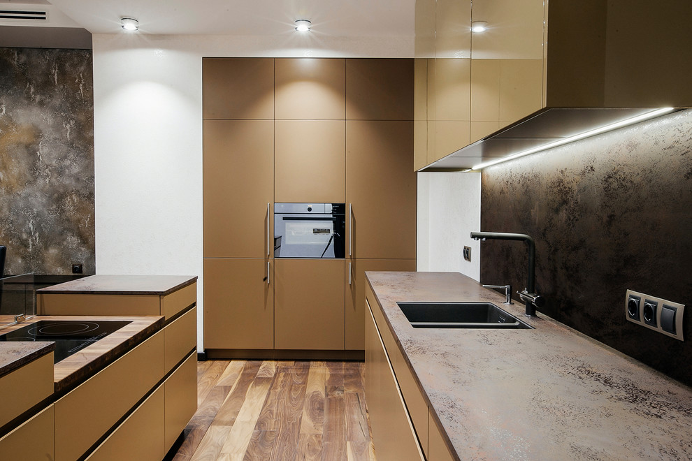 This is an example of a large contemporary galley kitchen in Saint Petersburg with dark hardwood floors, brown floor, an undermount sink, flat-panel cabinets, beige cabinets, brown splashback, black appliances, with island and brown benchtop.