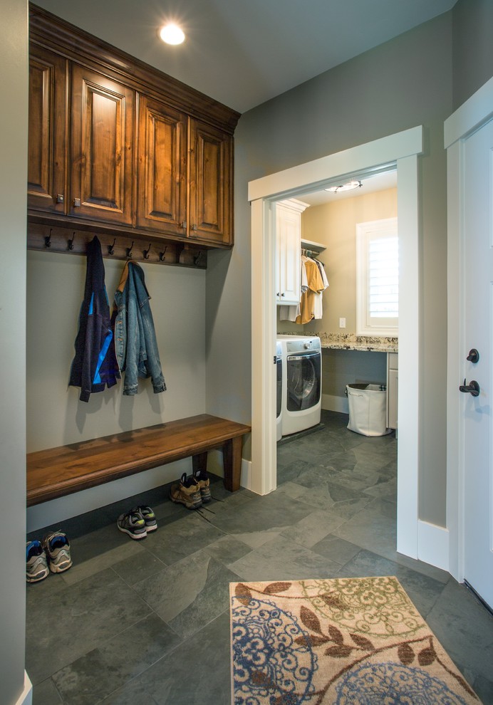 Photo of a mid-sized traditional mudroom in Salt Lake City with a white front door, grey walls, grey floor and slate floors.