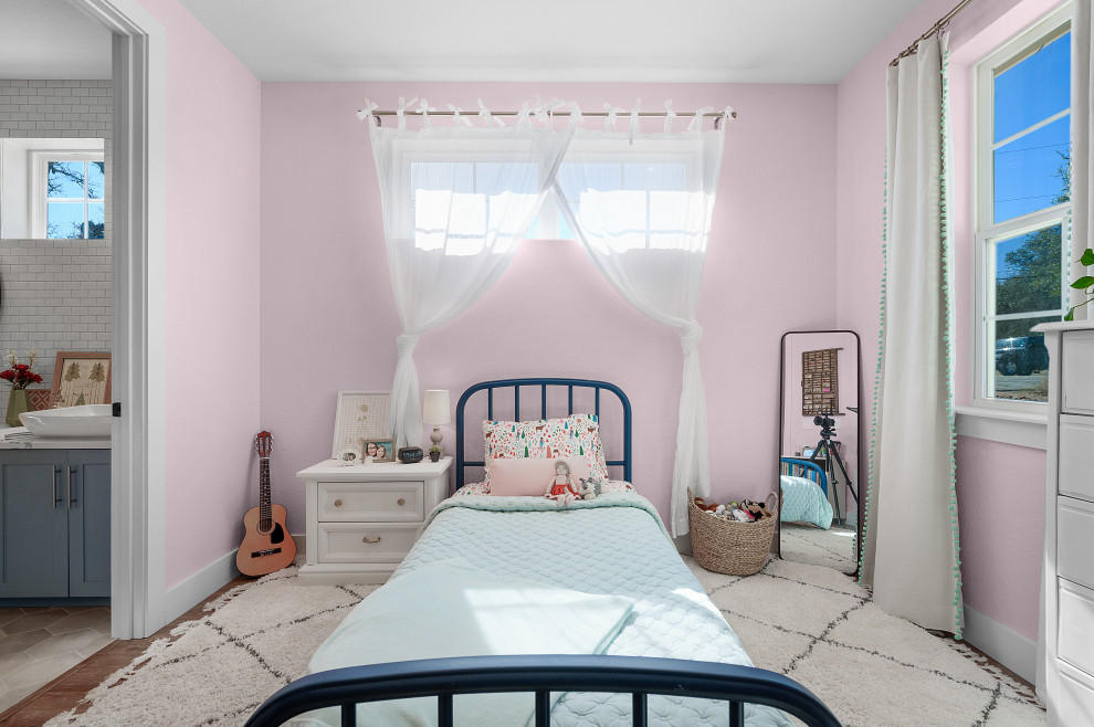 Inspiration for a medium sized country bedroom in Dallas with pink walls, medium hardwood flooring and brown floors.