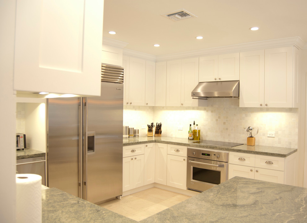 Design ideas for a contemporary kitchen in Miami with a drop-in sink, shaker cabinets, white cabinets, marble benchtops, white splashback, mosaic tile splashback, stainless steel appliances, porcelain floors and no island.