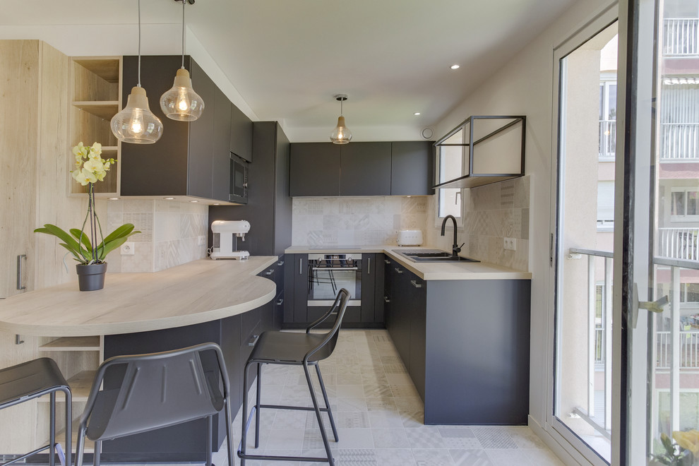 Photo of a mid-sized contemporary single-wall separate kitchen in Toulouse with a double-bowl sink, flat-panel cabinets, black cabinets, laminate benchtops, beige splashback, terra-cotta splashback, stainless steel appliances, ceramic floors, no island and beige floor.