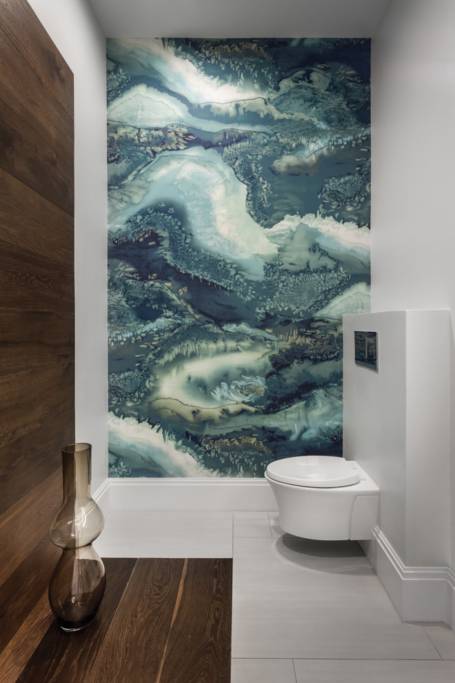 Inspiration for a mid-sized contemporary powder room in Tampa with a wall-mount toilet, grey walls, porcelain floors, grey floor, multi-coloured tile and stone slab.