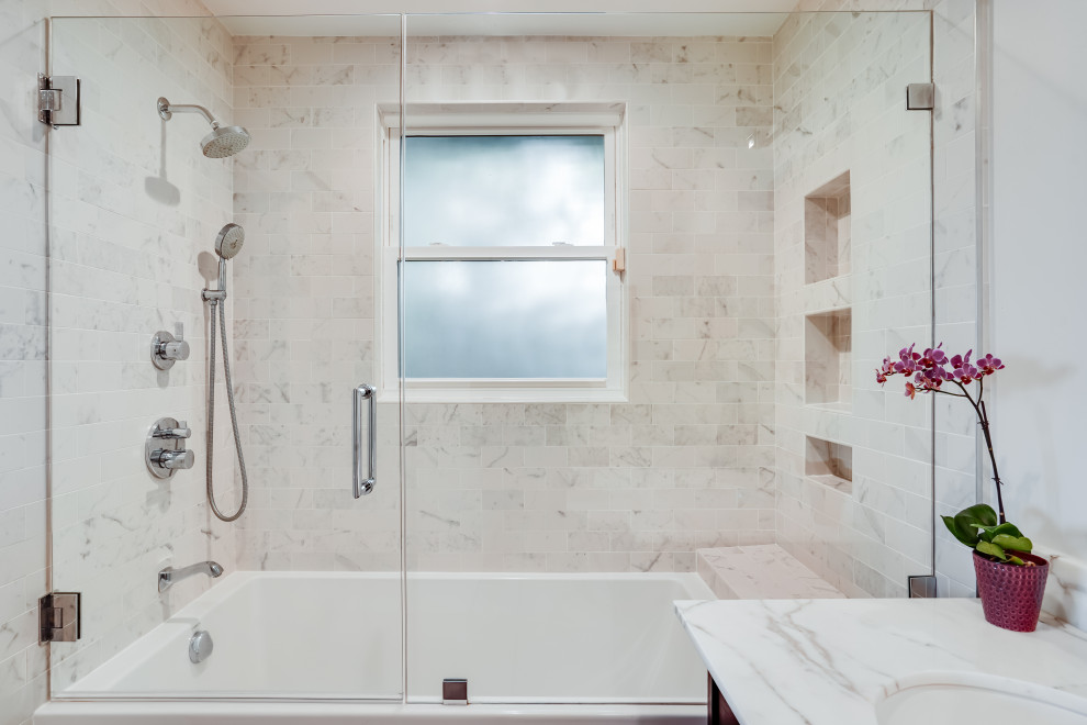 This is an example of a mid-sized transitional master bathroom in San Francisco with black cabinets, an alcove tub, a shower/bathtub combo, gray tile, marble, grey walls, an undermount sink, marble benchtops, a hinged shower door, grey benchtops, a niche, a single vanity and a freestanding vanity.