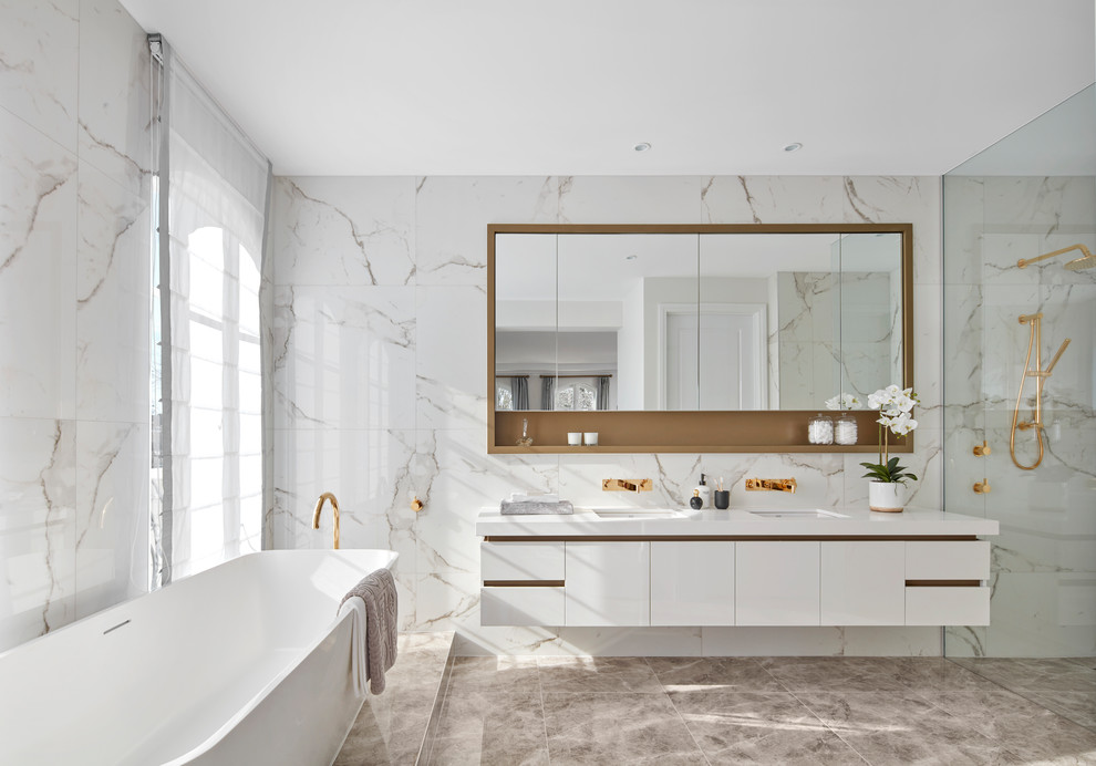 Inspiration for a contemporary master bathroom in Melbourne with flat-panel cabinets, white cabinets, a freestanding tub, a corner shower, black and white tile, white walls, an undermount sink and brown floor.