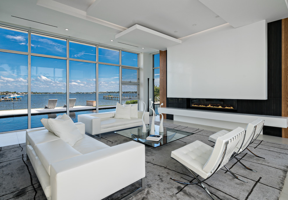 This is an example of a contemporary formal open concept living room in Miami with a ribbon fireplace.