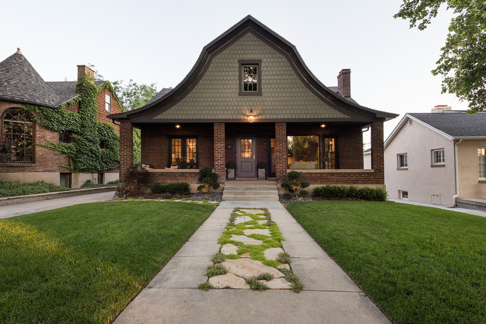 Inspiration for an arts and crafts two-storey exterior in Salt Lake City with mixed siding.