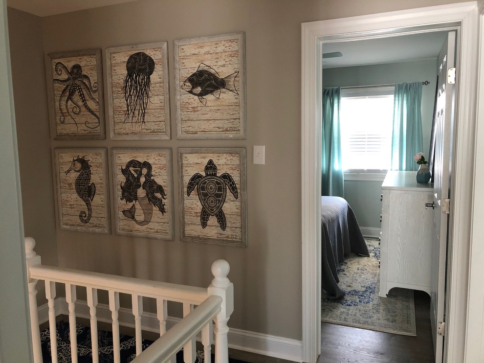 Photo of a small beach style hallway in Philadelphia with beige walls, vinyl floors and grey floor.