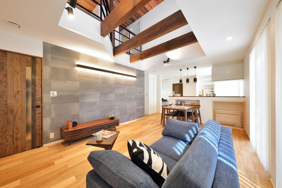 This is an example of a mid-sized midcentury open concept living room in Other with multi-coloured walls, medium hardwood floors and brown floor.