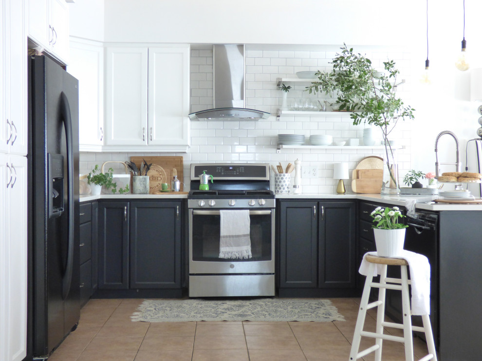 Kitchen - transitional u-shaped beige floor kitchen idea in Toronto with recessed-panel cabinets, black cabinets, white backsplash, subway tile backsplash, stainless steel appliances, a peninsula and white countertops