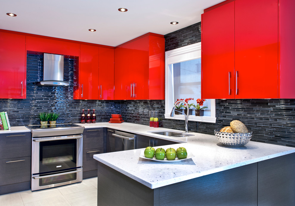 Photo of a contemporary u-shaped kitchen in Montreal with a double-bowl sink, flat-panel cabinets, red cabinets, black splashback, matchstick tile splashback and stainless steel appliances.