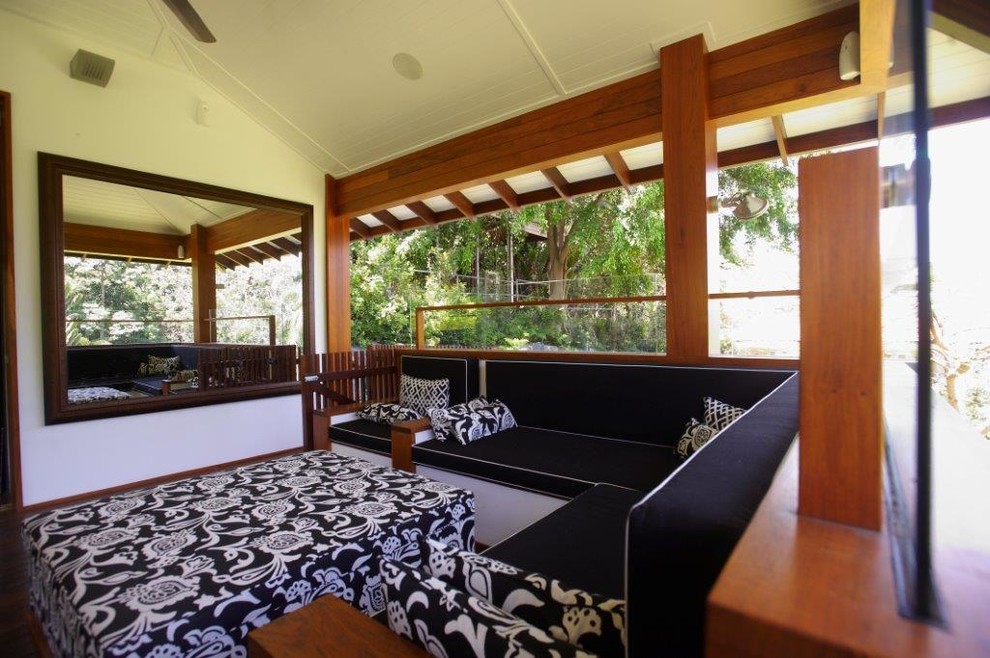 Large beach style front yard patio in Brisbane with decking and a roof extension.