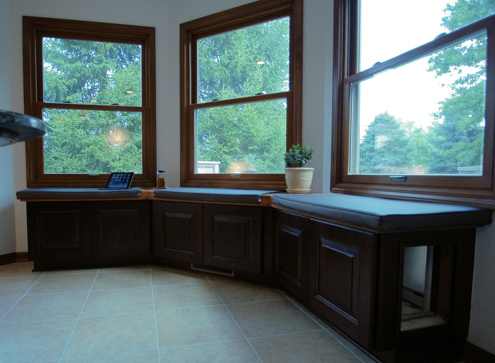 Eat-in kitchen - large transitional l-shaped eat-in kitchen idea in Columbus with an undermount sink, raised-panel cabinets, dark wood cabinets, granite countertops, gray backsplash, ceramic backsplash, stainless steel appliances and an island