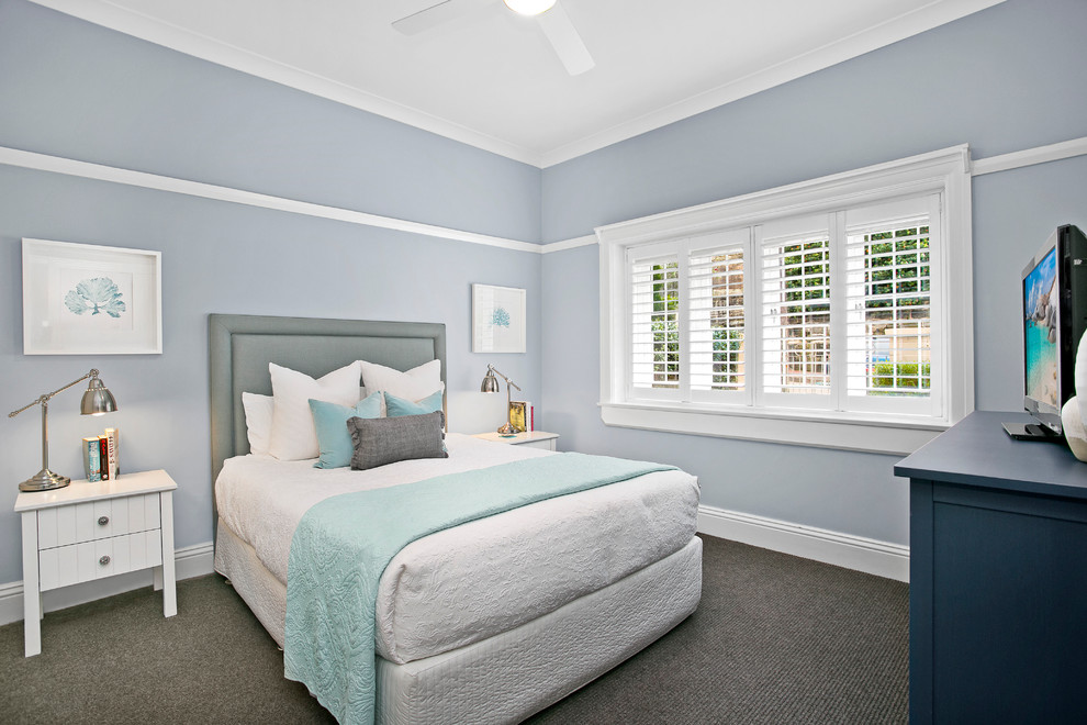 Inspiration for a small beach style master bedroom in Sydney with blue walls and carpet.