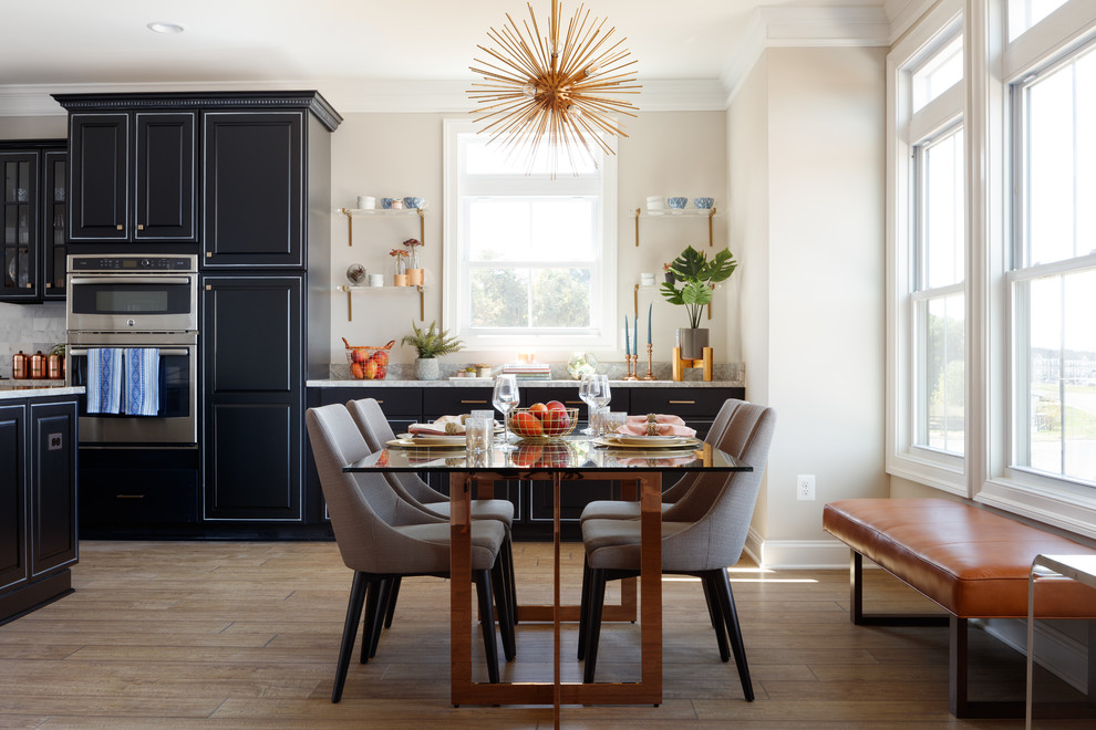 Mid-sized transitional dining room in Other with beige walls, laminate floors and brown floor.